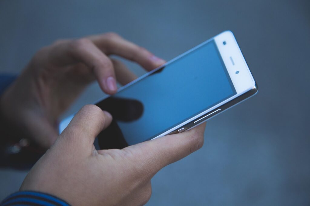 Hands, phone and smartphone, illustrating: Apple Intelligence reaches China in iOS 27.3, but without the new Siri